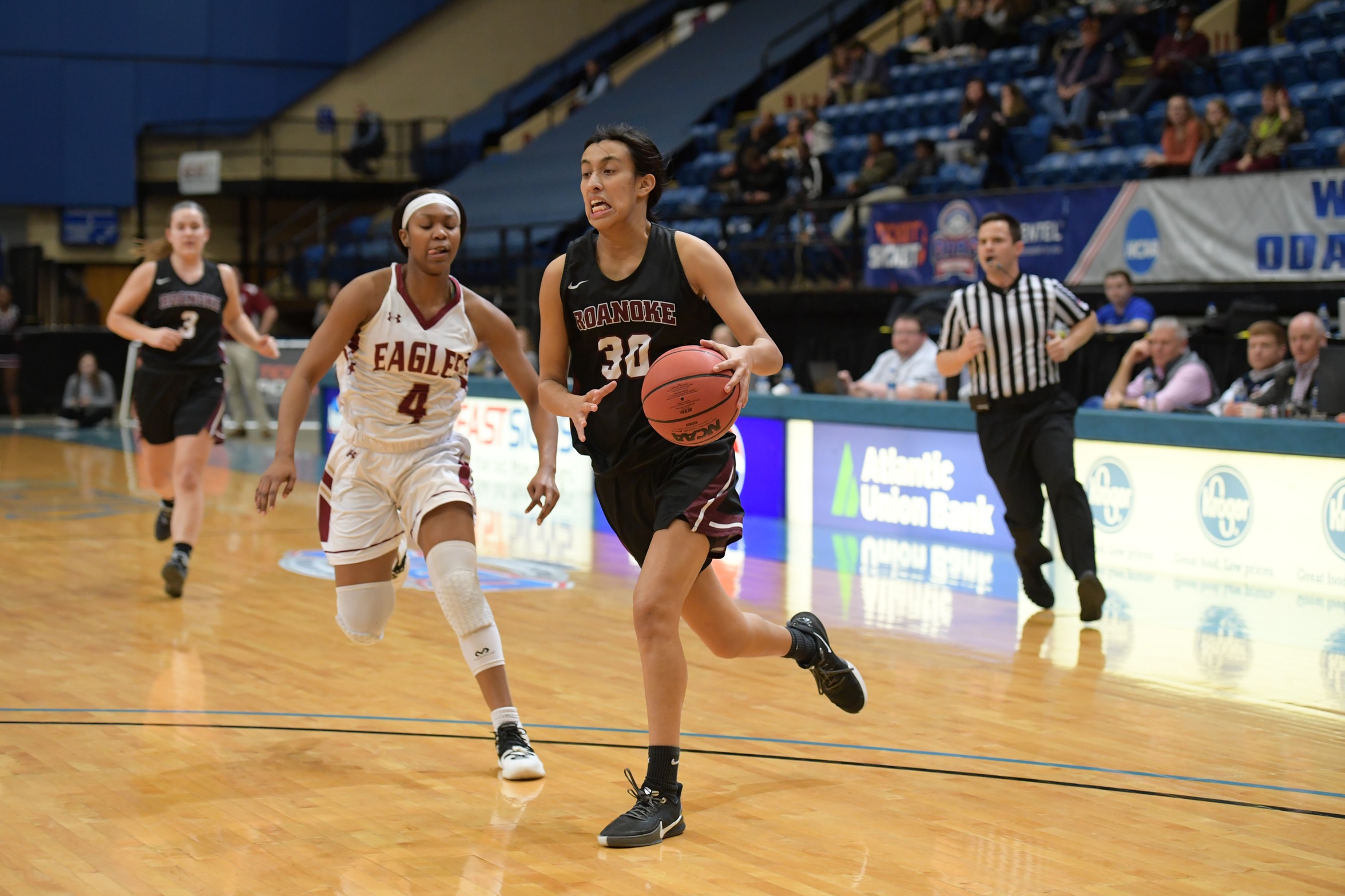 action picture of RC basketball player Renee Alquiza driving to the basket