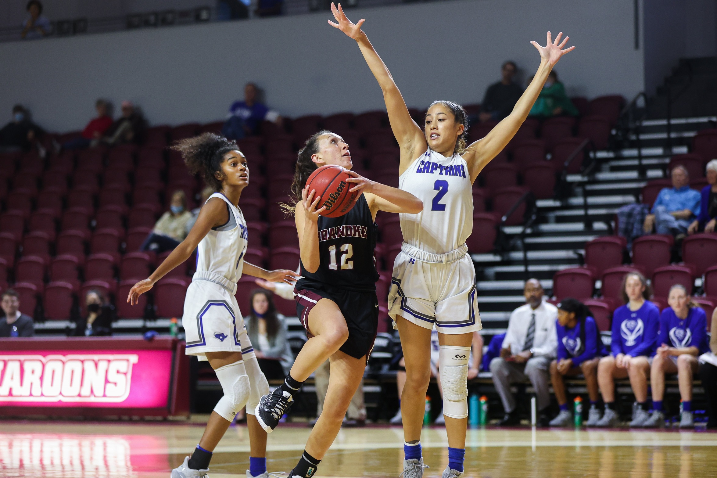 action photo of RC women's basketball player Kristina Harrel driving to the basket
