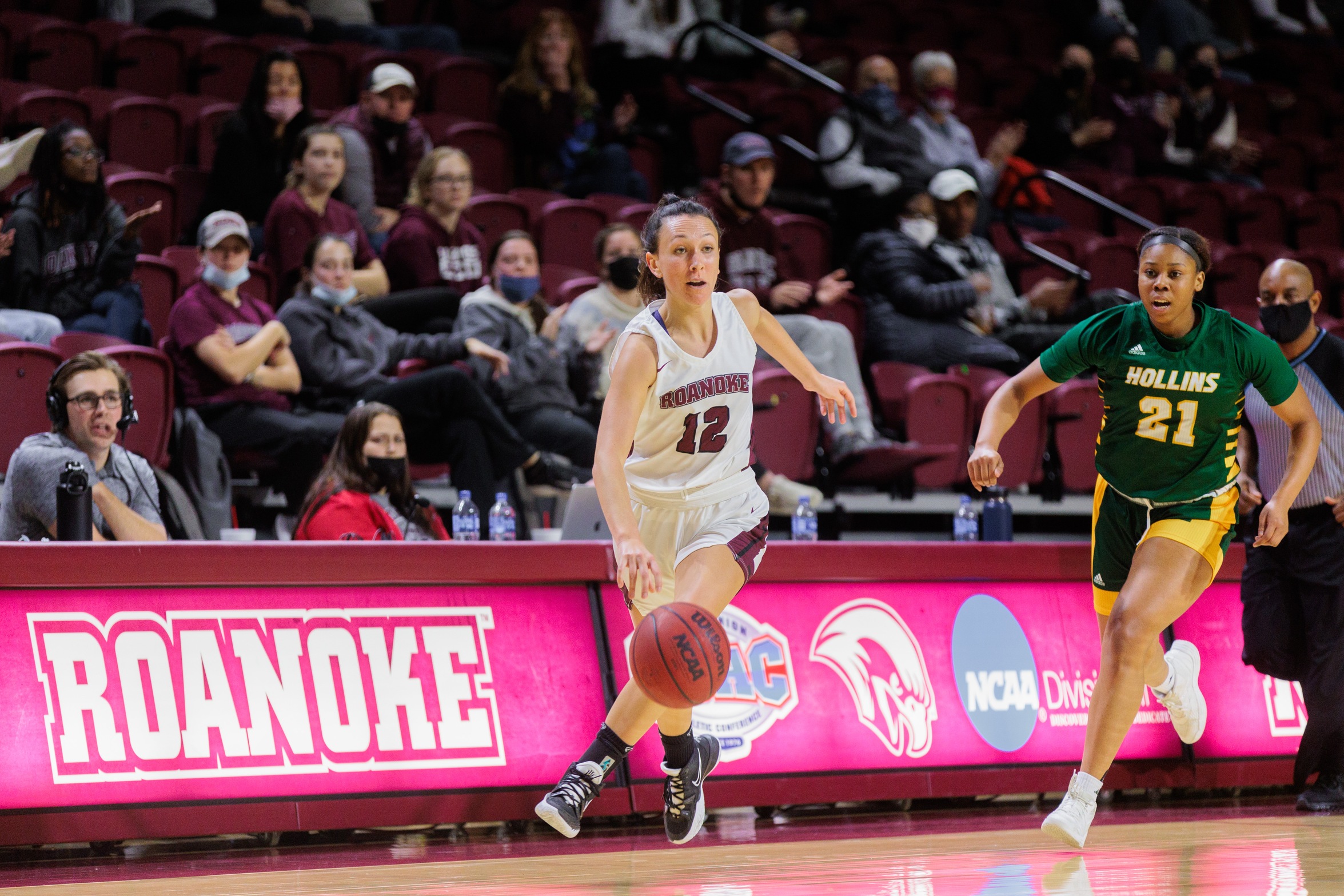 action photo of RC women's basketball player Kristina Harrel driving down th ecourt
