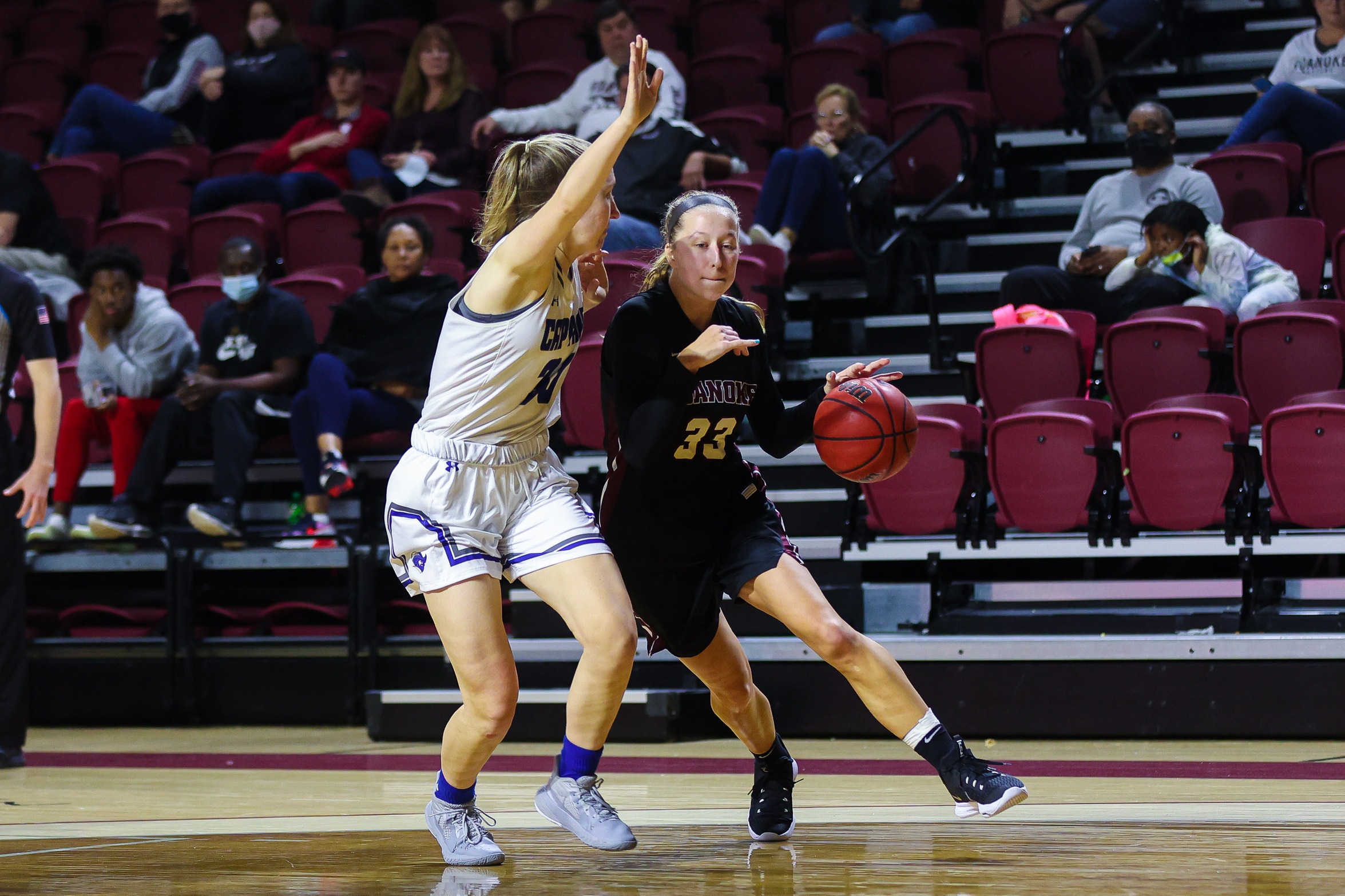 action photo of RC WBB Rose Sande driving past a defender