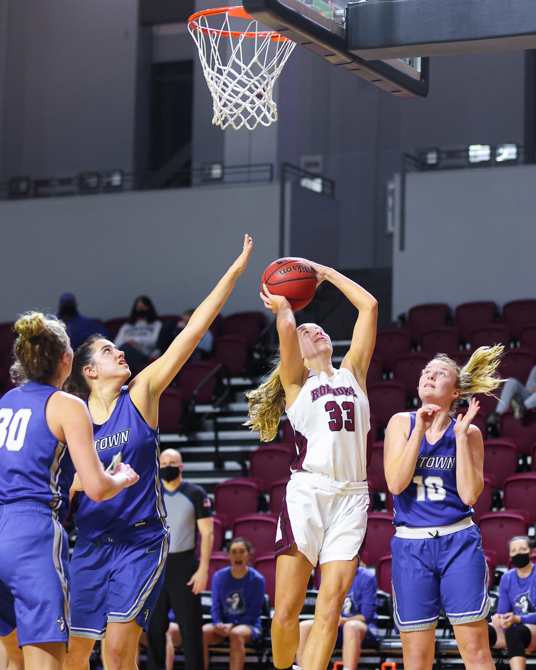 action photo of RC women's basketball player Rose Sande scoring 
