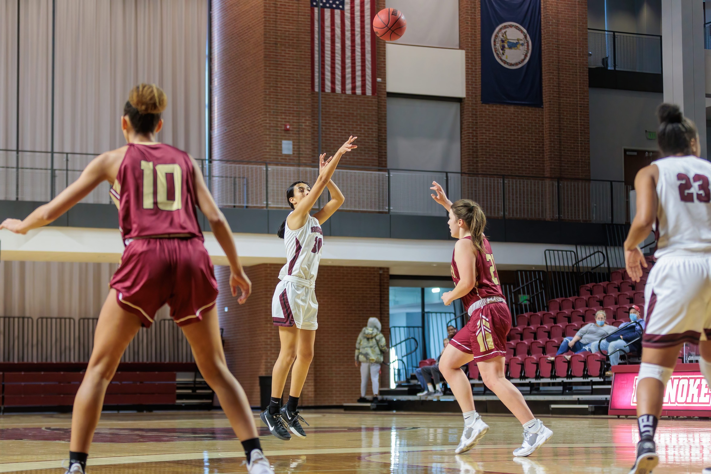 action shot of RC WBB Renee Alquiza with a three pointer