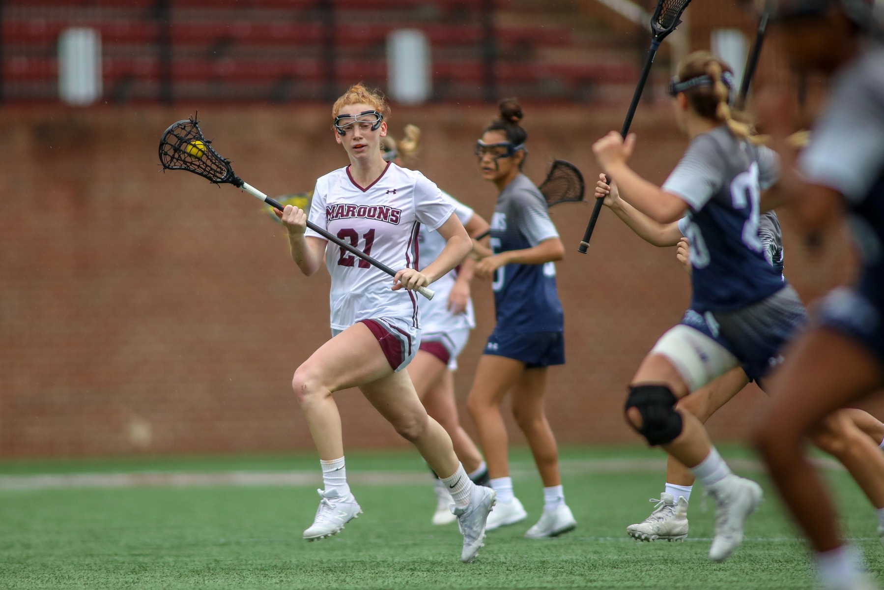 action photo of RC WLAX player Emerson Foster driving past a defender