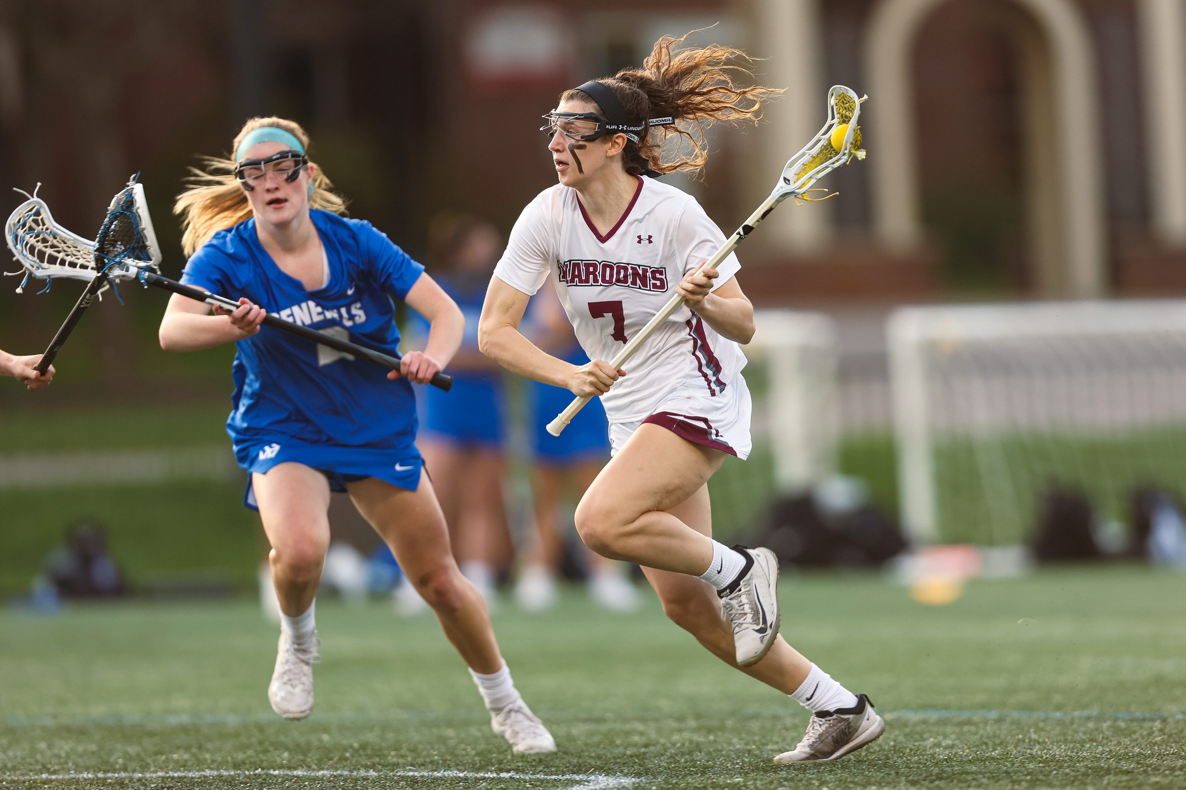 action photo of RC lacrosse player Lilly Blair going past a defender