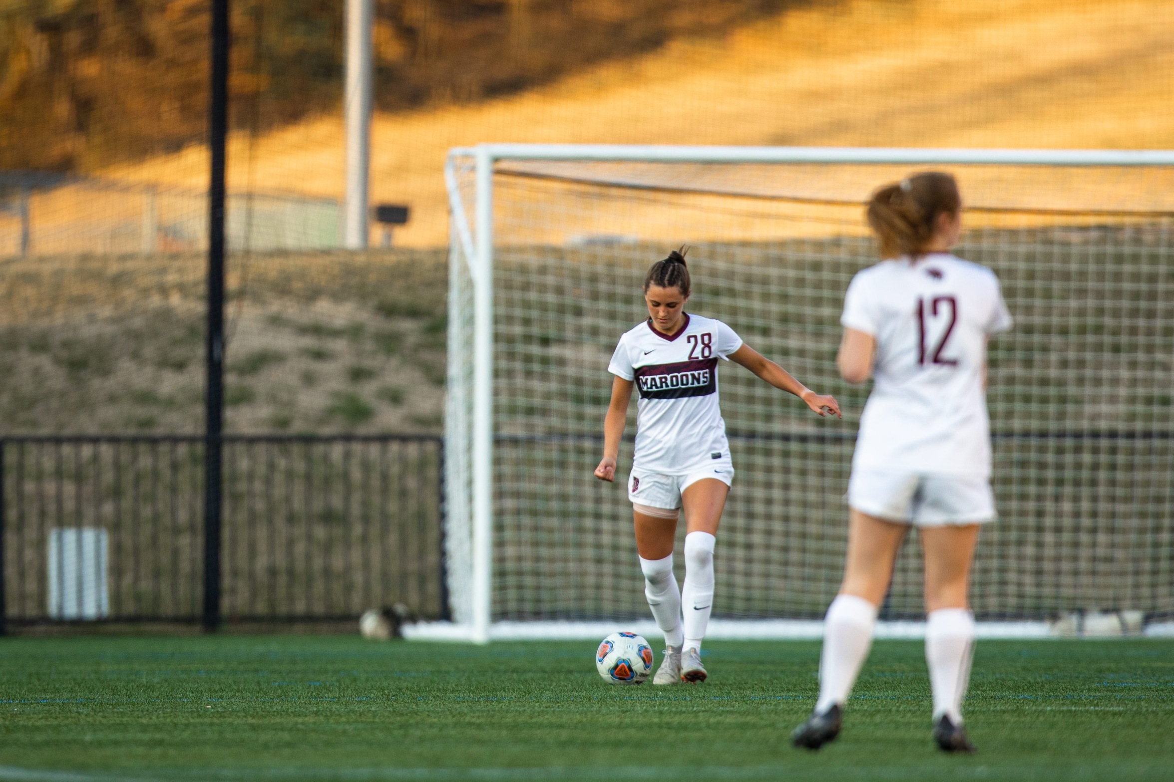action photo of RC soccer player Emma Woods with a free kick