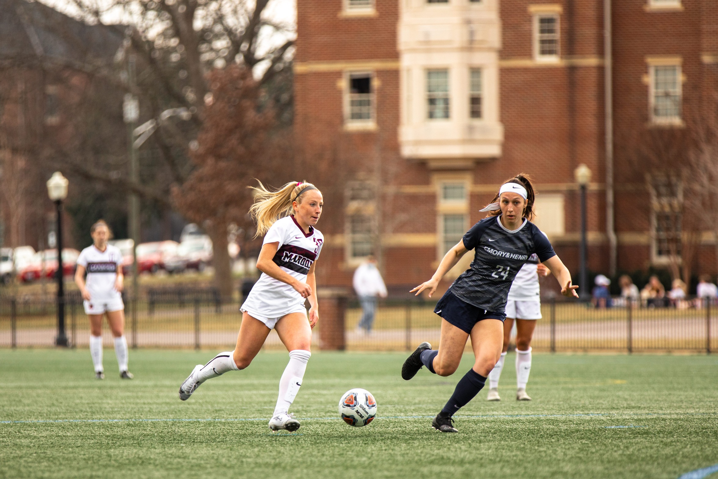 action photo of RC soccer player Morgan O'Neill dribbling past a defender