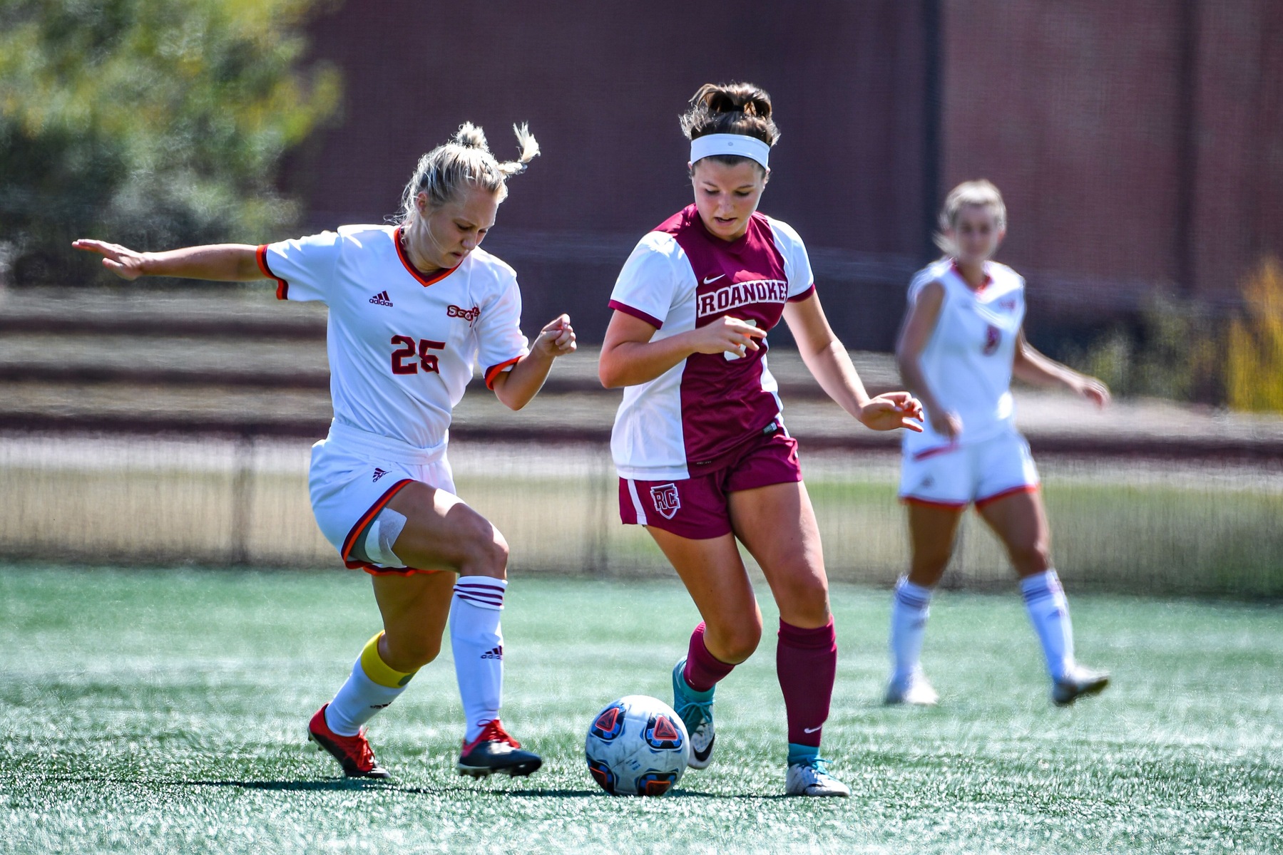 action photo of RC soccer player Ellie Schad dribbling against a defender