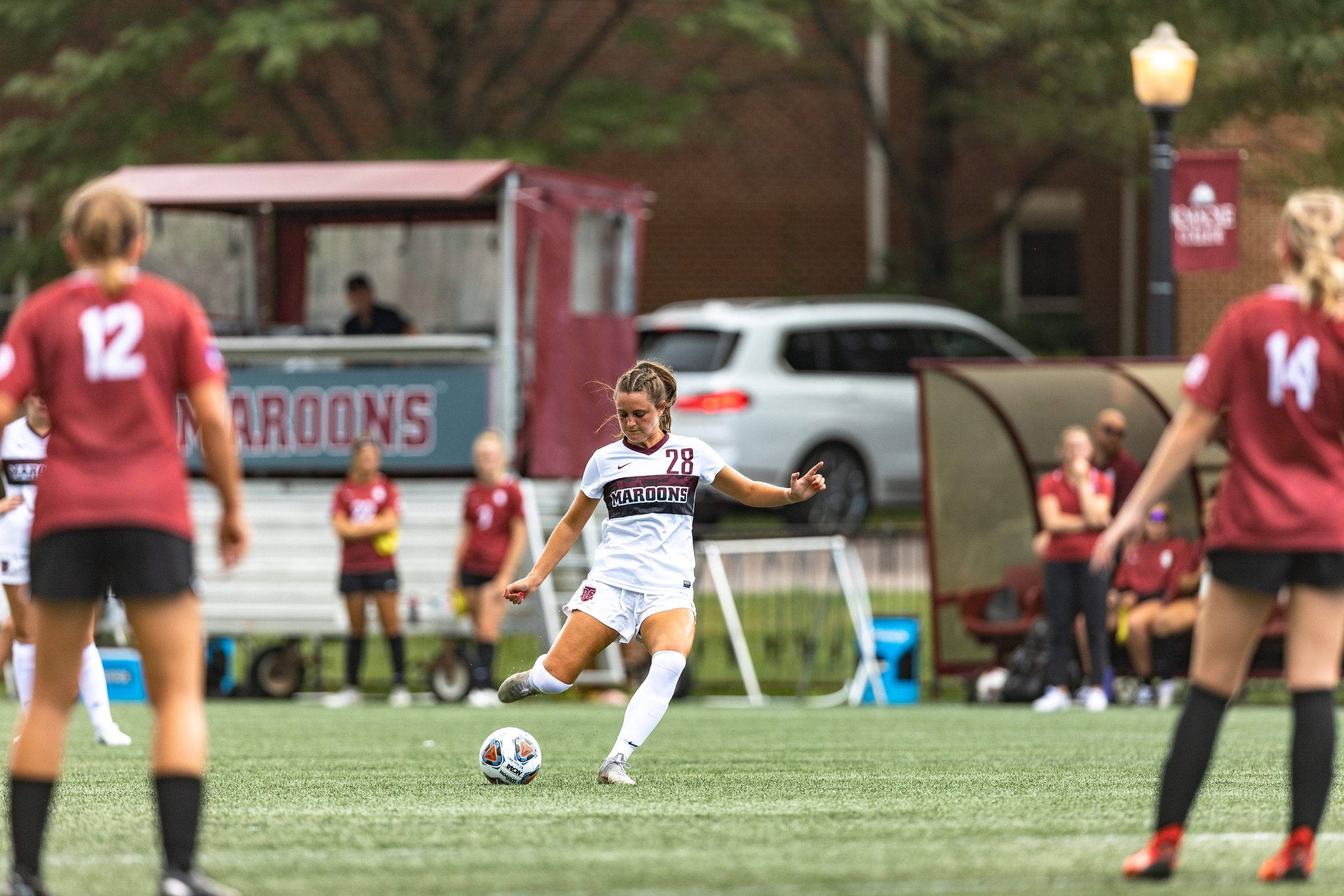 action photo of RC women's soccer player Emma Woods with a free kick