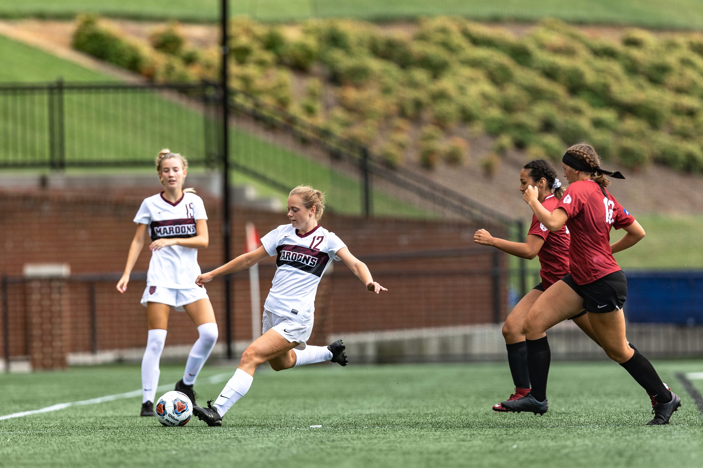 action photo of RC women's soccer player Logan Tyler striking the ball