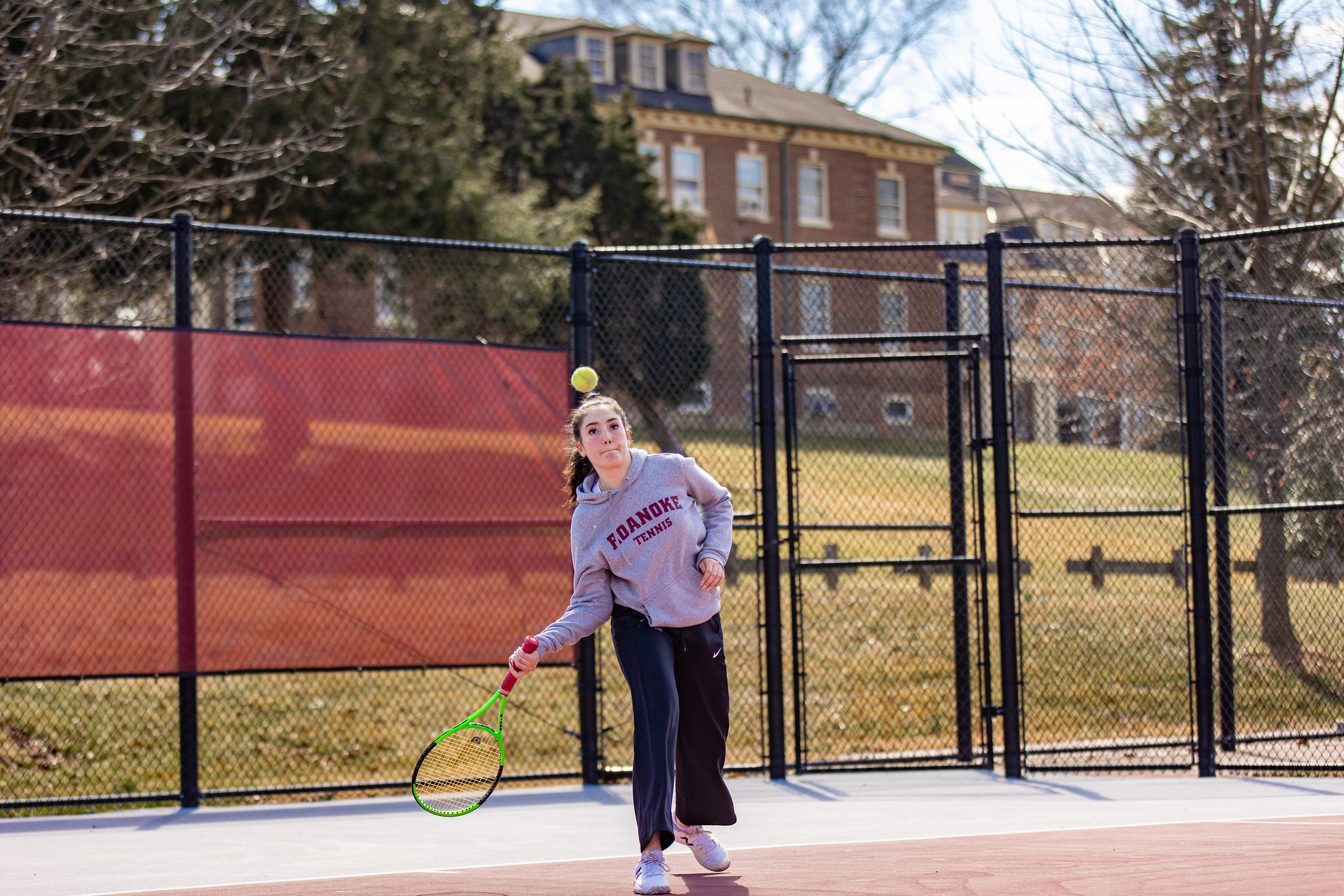 action photo of RC tennis player Margriet Bostoen hitting a forehand