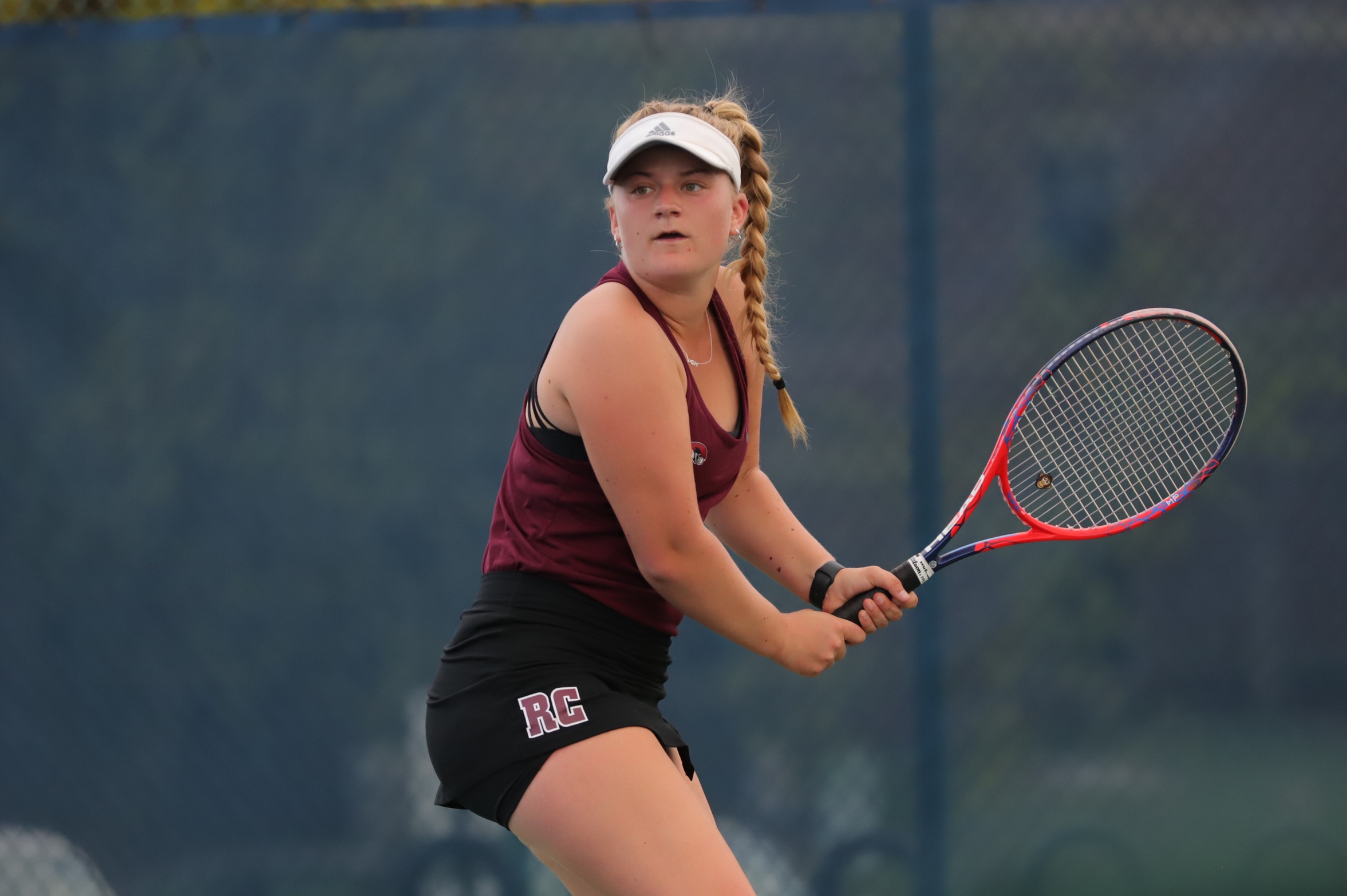 action photo of RC women's tennis player hitting a backhand