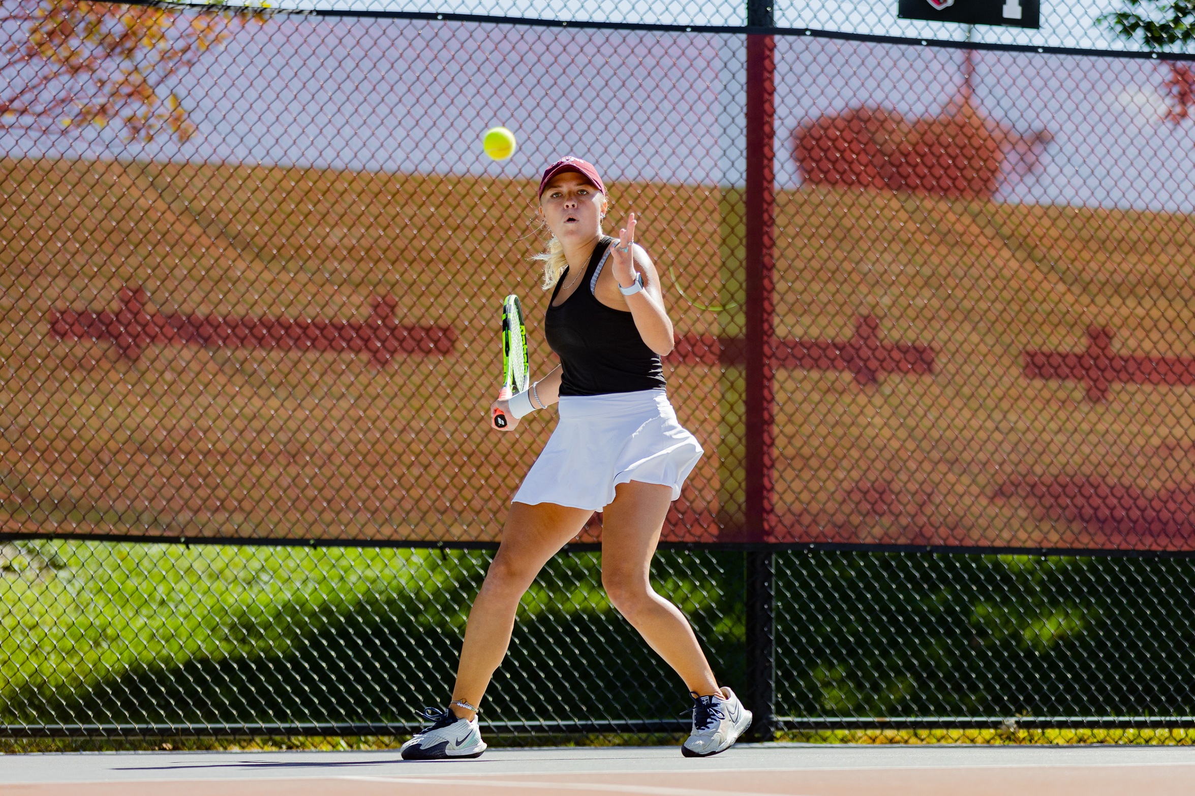 action photo of RC women's tennis player hitting a forehand