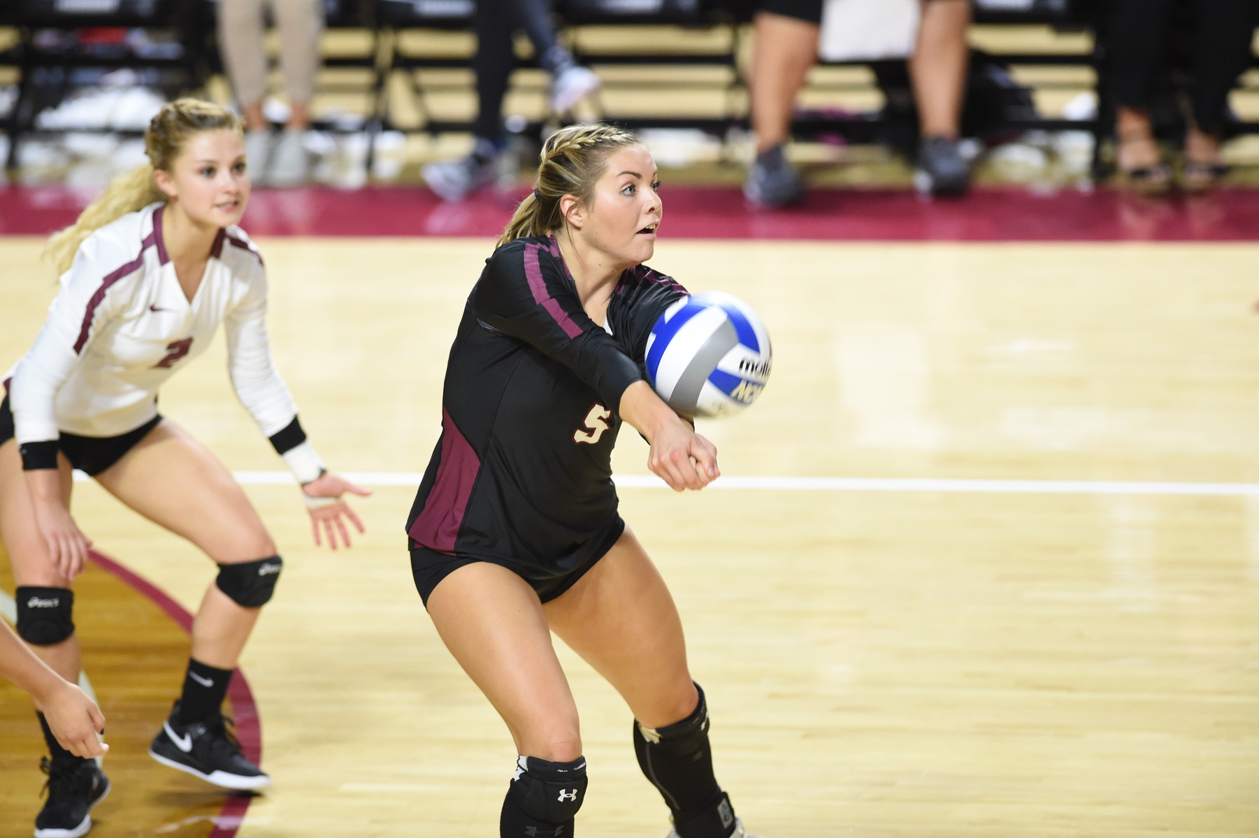 action photo of two RC volleyball players returning serve