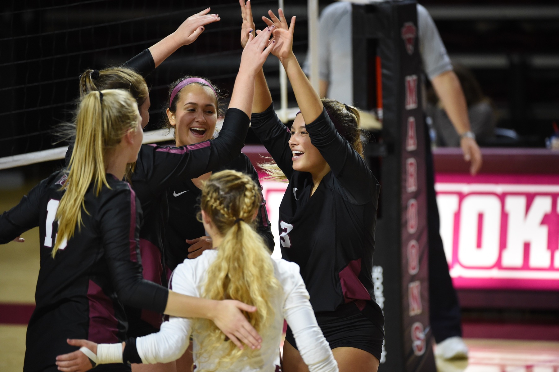 action photo of the RC volleyball team celebrating a point