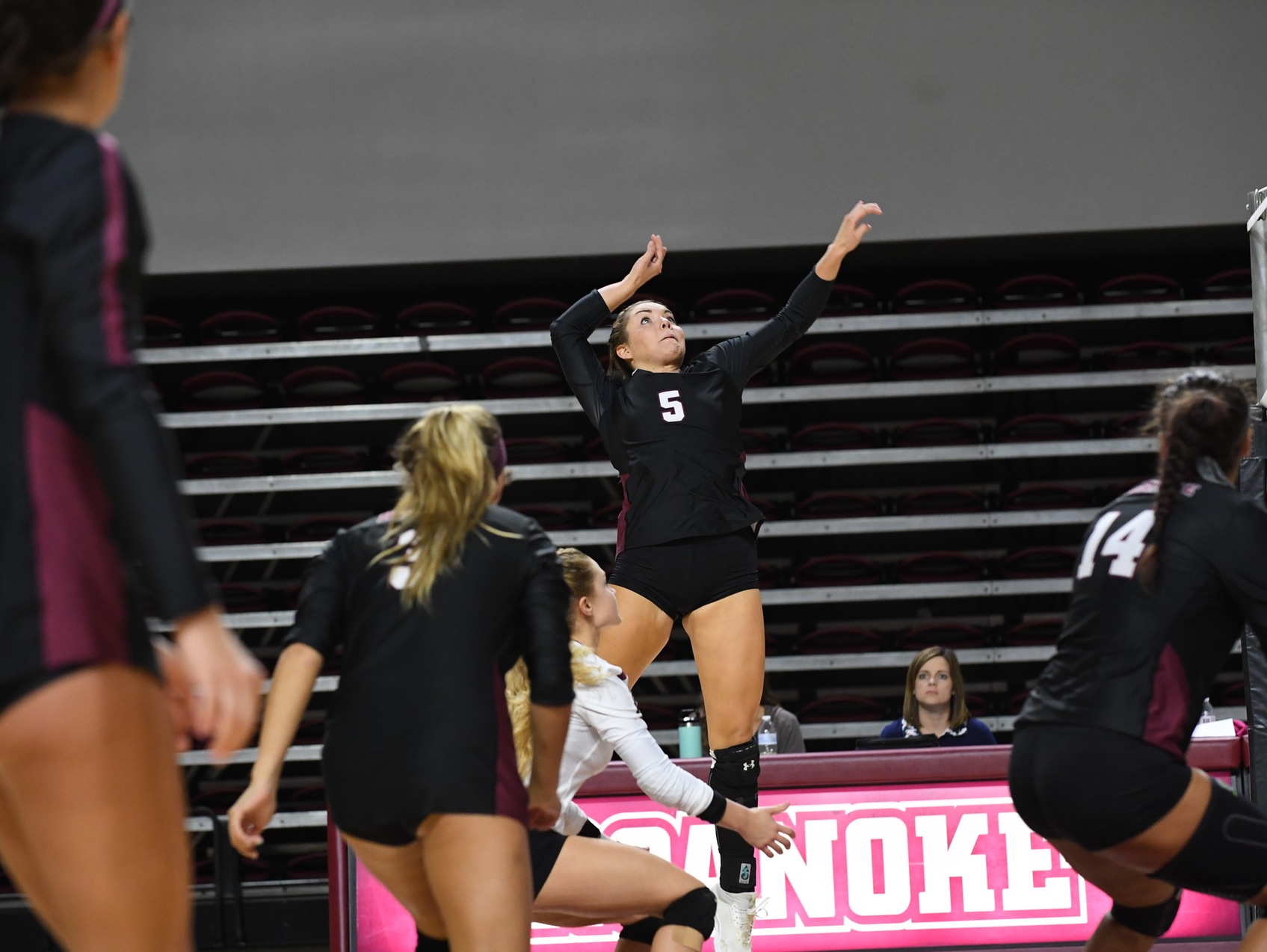 action photo of volleyball player Linsey Bailey attacking at the net