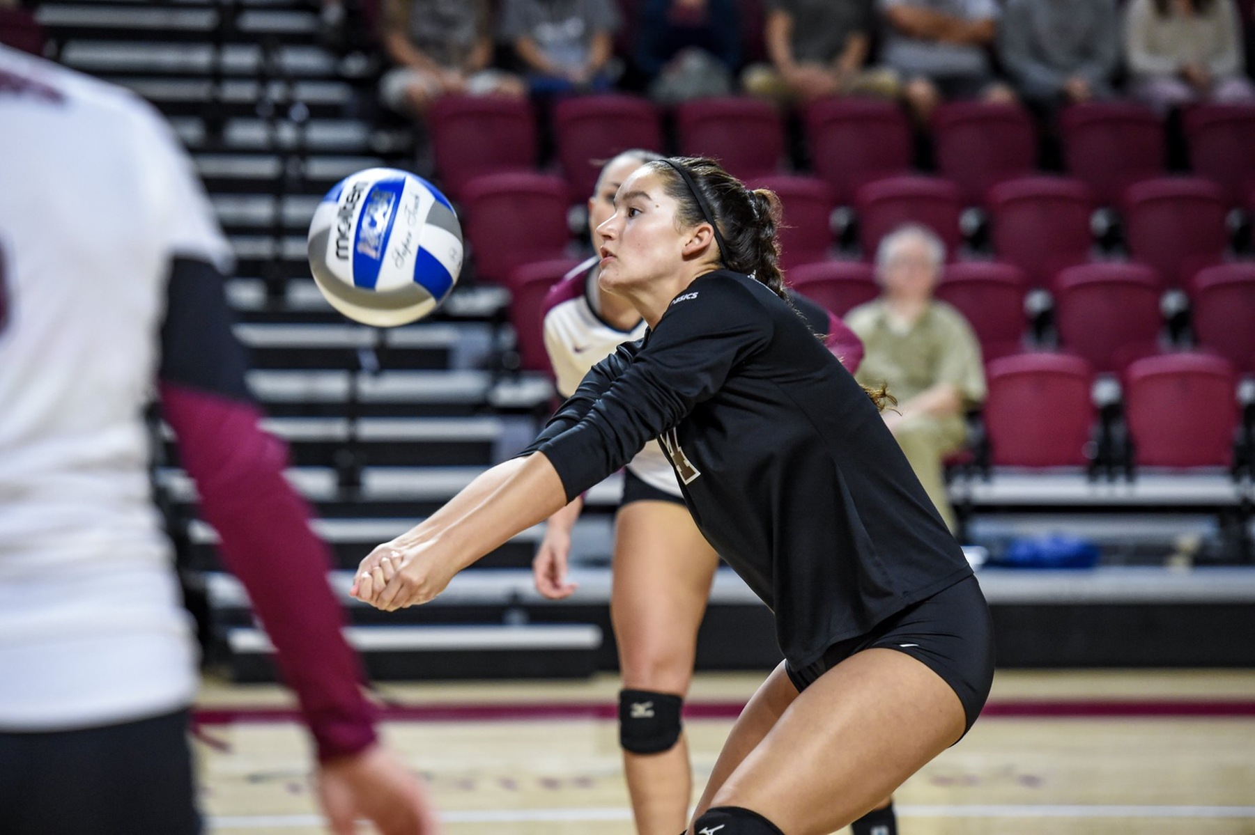 action photo of RC volleyball player Tori Clineville digging a ball