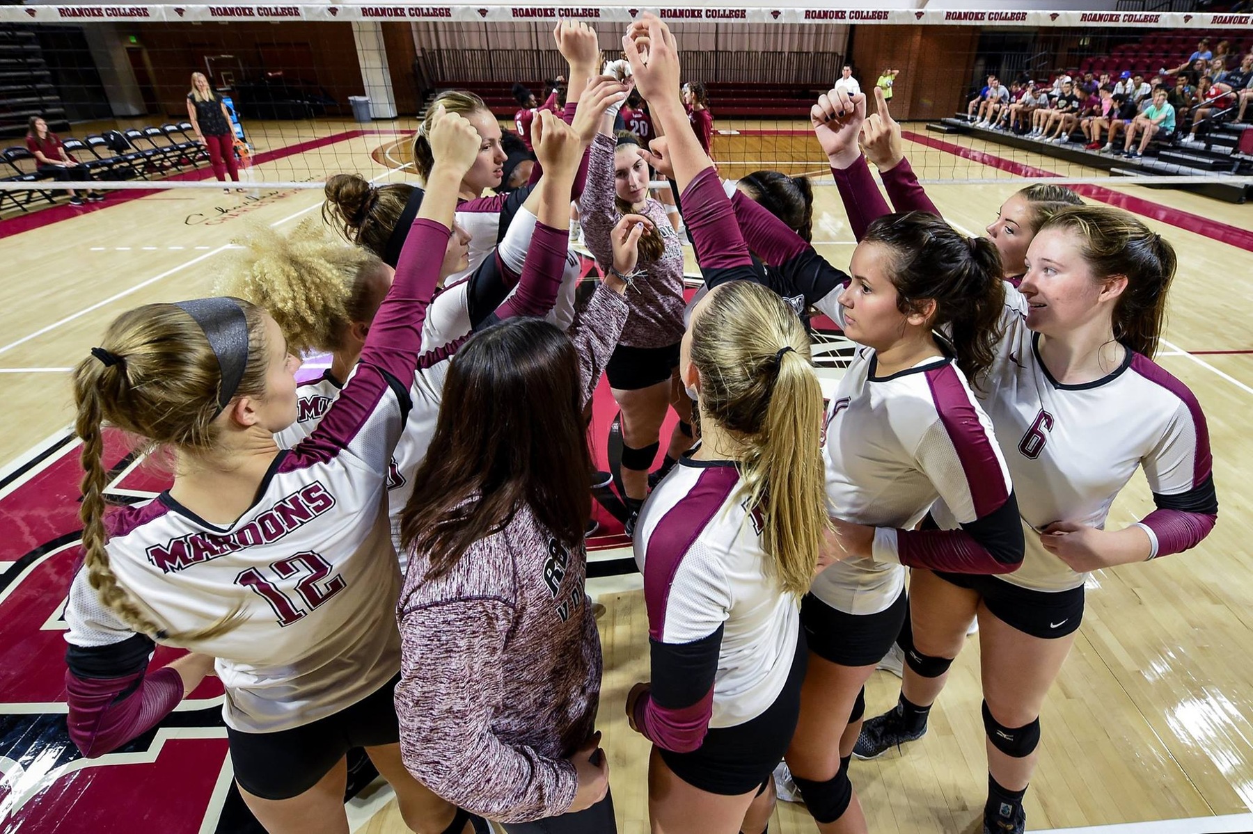 action shot of the RC volleyball team in a huddle