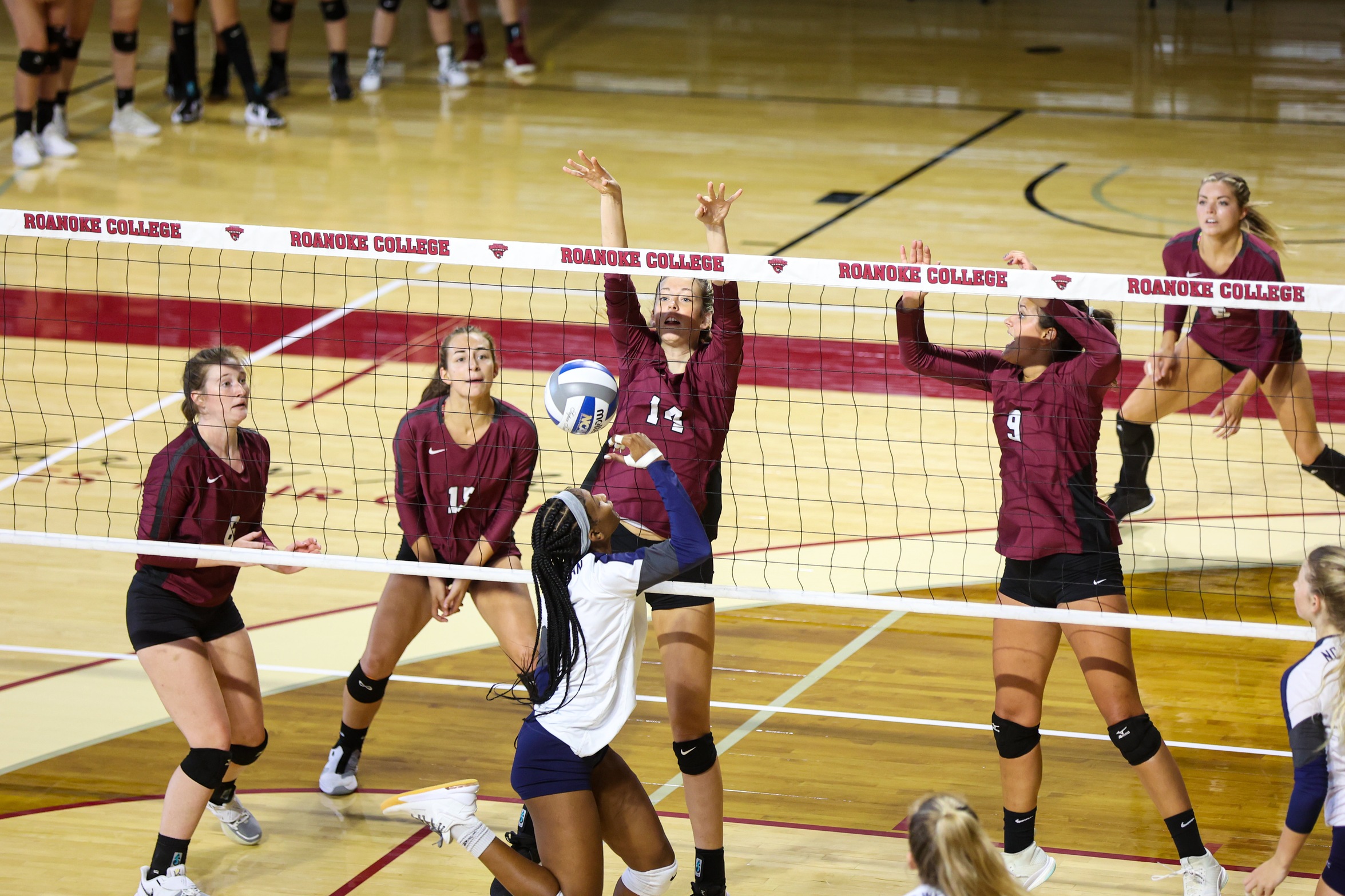 action photo of RC volleyball player Ryanna Clark (14) blocking at the net