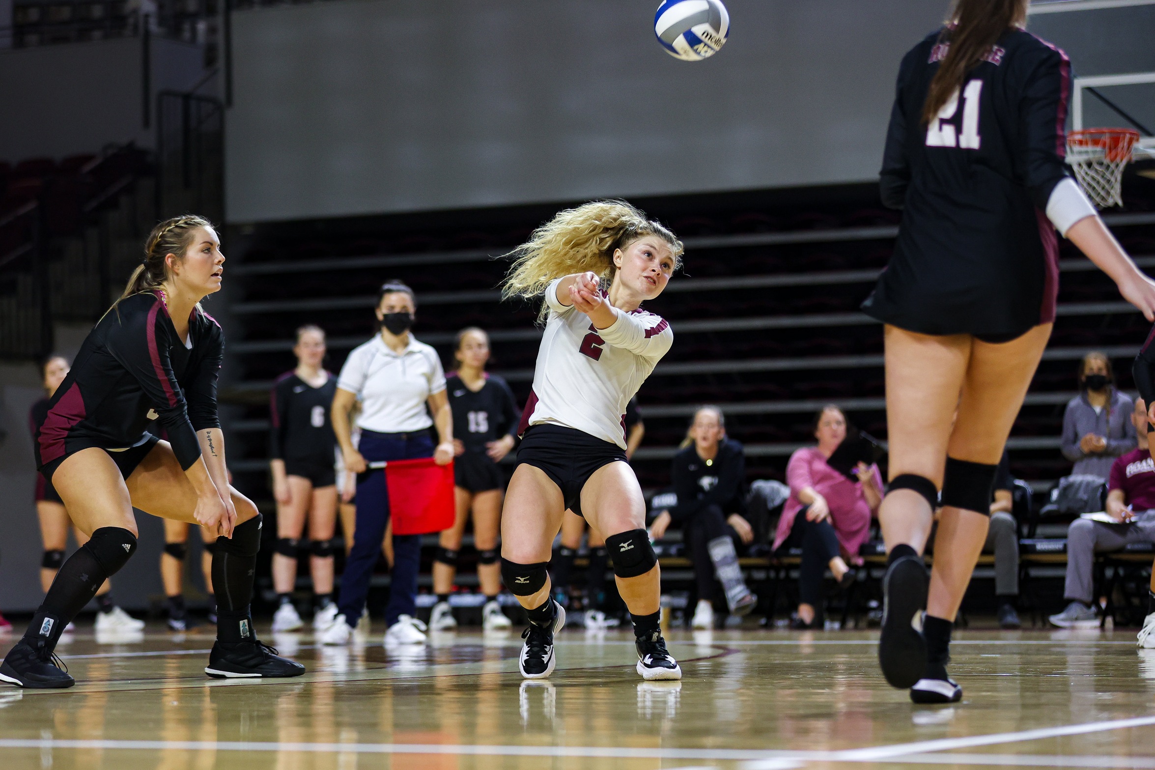 action photo of RC volleyball player Kennedy Clemmer with a dig