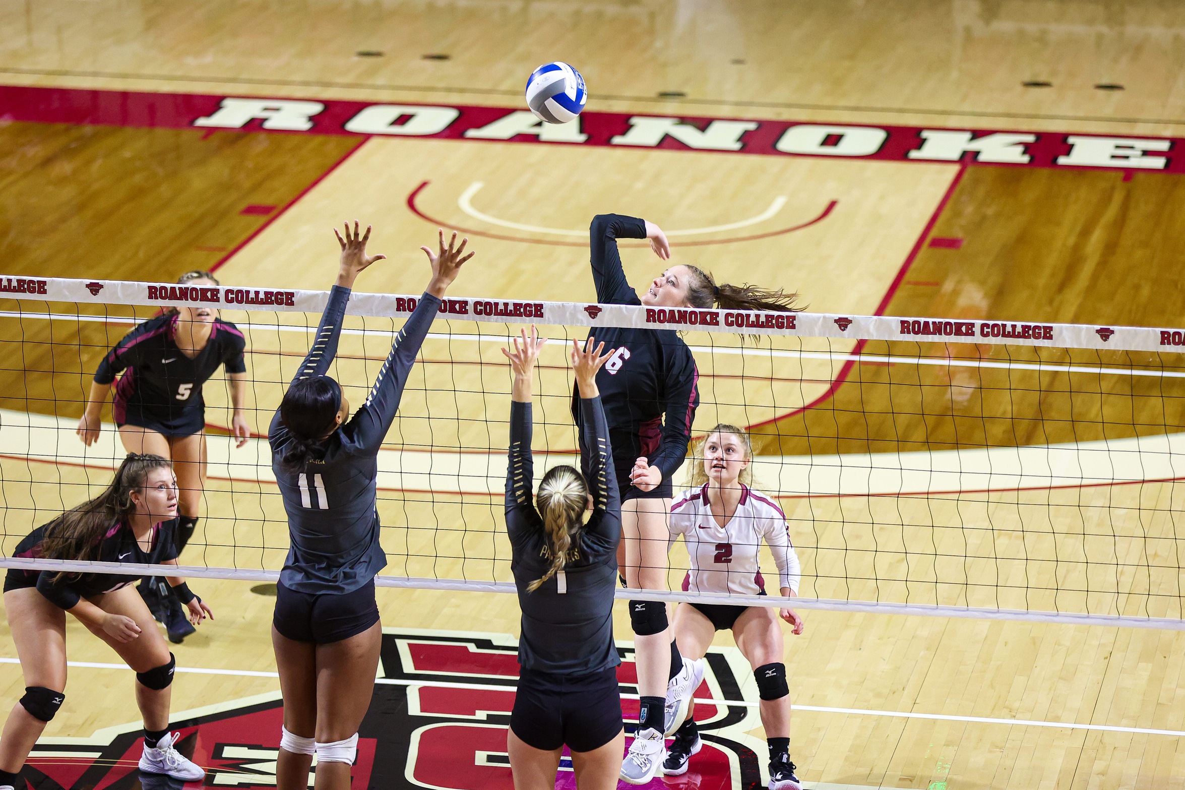 action photo of RC volleyball player Parker Moody with an attack against two defenders